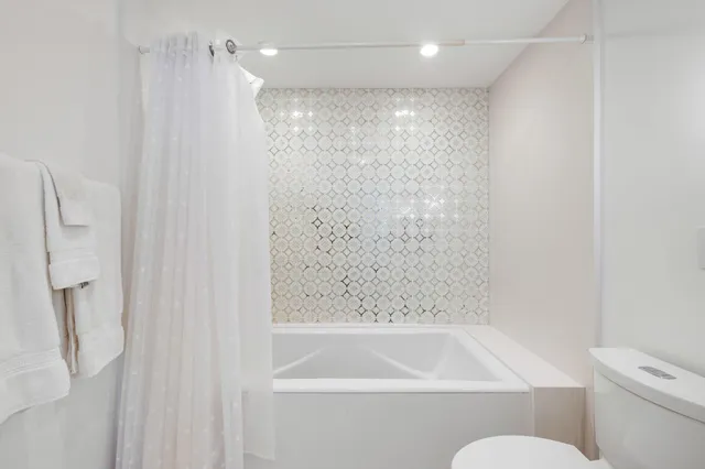 a bathroom with a shower and a toilet