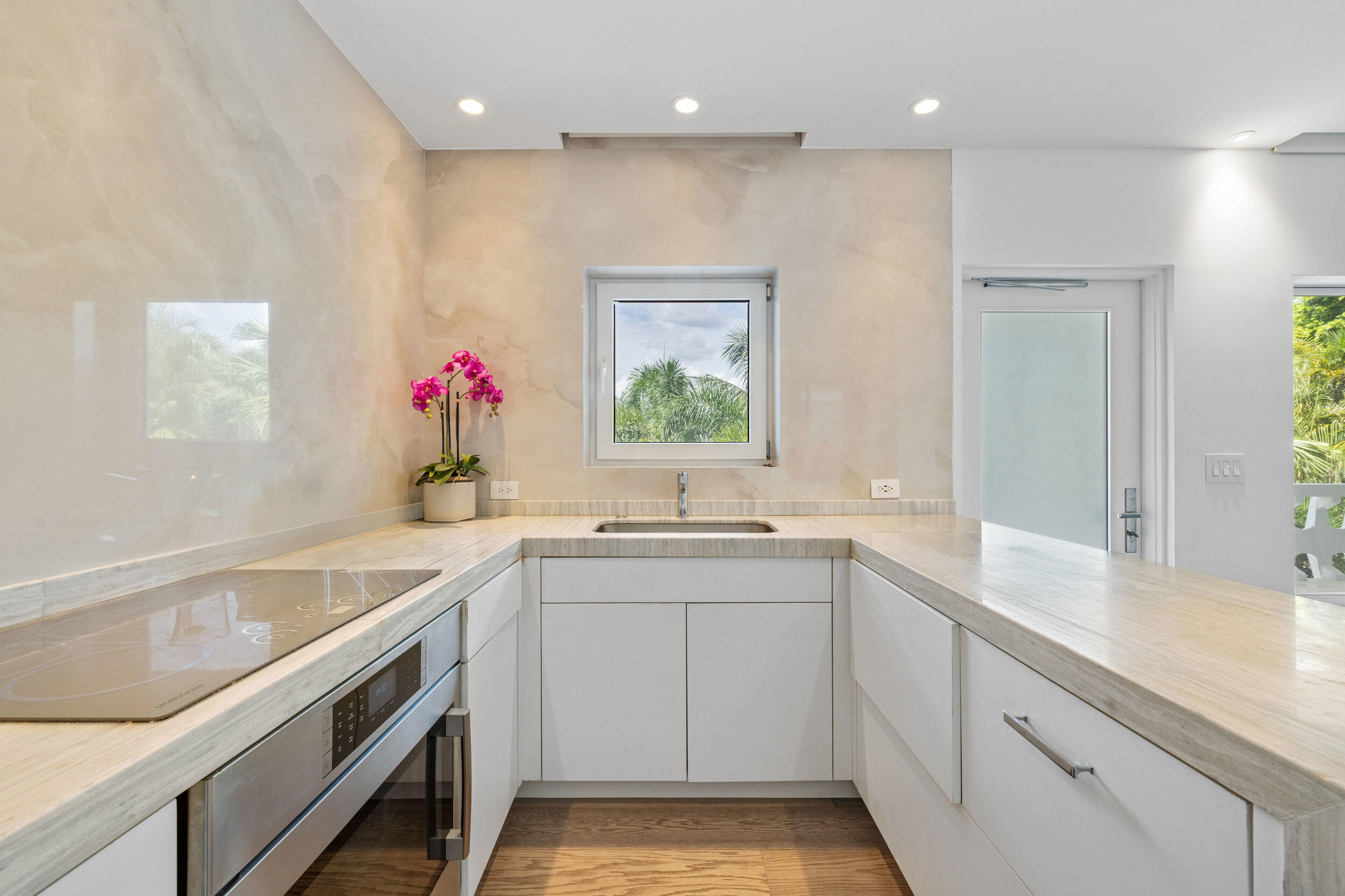 300 South Ocean Boulevard, Unit 3F Palm Beach, FL 33480 - Photo 6 of 27 a kitchen with a sink stove and cabinets