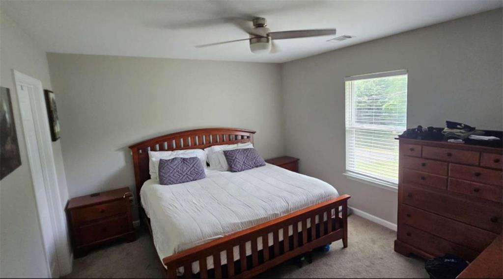 2956 Westmoreland Road Cleveland, GA 30528 - Photo 12 of 22 a bedroom with a bed a dresser and a window