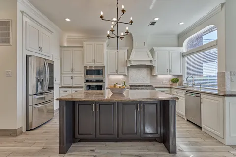 a view of a room with wooden floor fireplace and windows