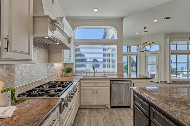 a kitchen with stainless steel appliances granite countertop a stove and a sink