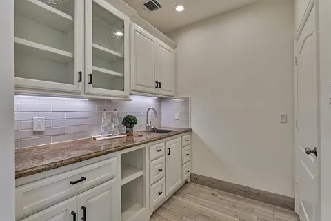 a kitchen with stainless steel appliances granite countertop a sink and cabinets