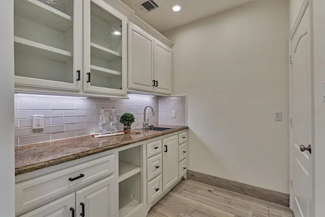 a kitchen with stainless steel appliances granite countertop a sink and cabinets
