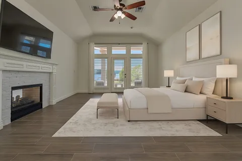 a large white bed in a living room with a fireplace