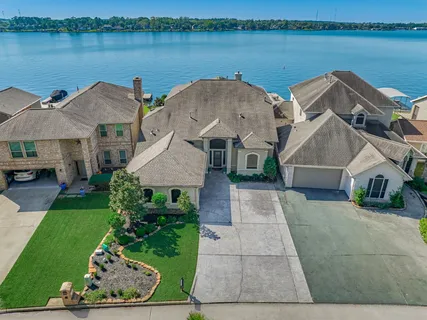 an aerial view of a house with garden space and lake view