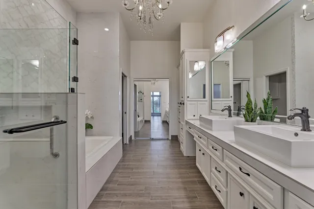 a bathroom with a double vanity sink a mirror and a shower
