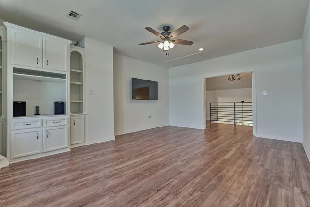 a bathroom with a granite countertop sink a toilet and shower