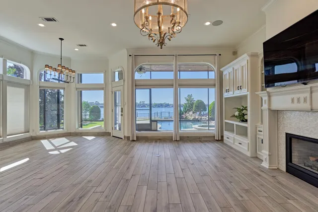 a view of a kitchen with furniture a flat screen tv and wooden floor
