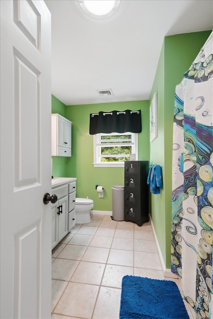 26 Davis Circle Warwick, RI 02886 - Photo 27 of 50 The generously sized main bath features an updated oversized vanity with ample cabinetry, modern lighting and fixtures, durable tile flooring, a full tub/shower combination, and a large linen closet for added storage.