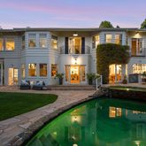a front view of a house with swimming pool having outdoor seating
