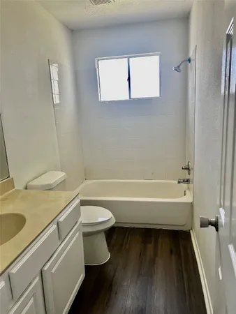 a bathroom with a sink a toilet and bathtub