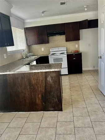 a kitchen with stainless steel appliances a sink and cabinets