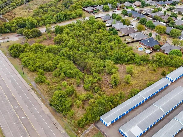 a view of a yard with potted plants