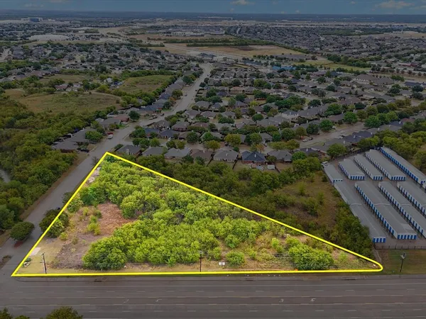 a view of a yard with a wooden fence