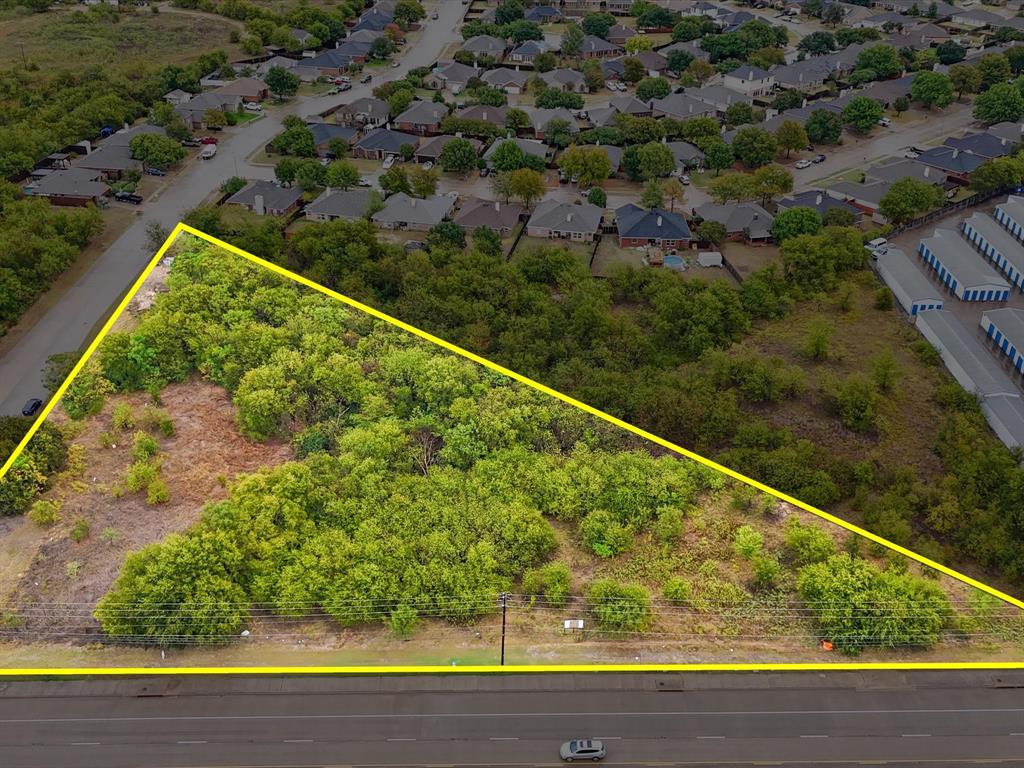 713 South Crowley Road Crowley, TX 76036 - Photo 5 of 24 a view of a yard with a wooden fence