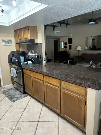 a kitchen with stainless steel appliances granite countertop a sink stove and cabinets