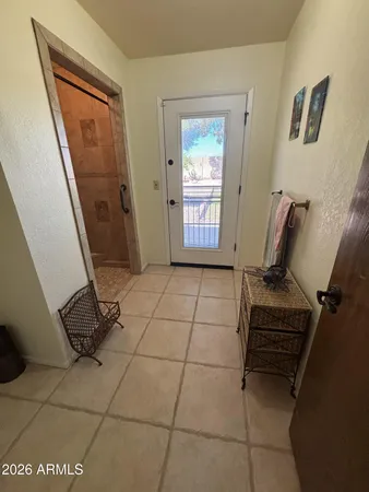 a living room with a furniture a rug and a window