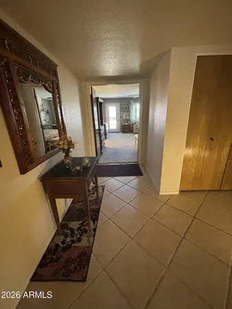 a view of a hallway with wooden floor and glass door