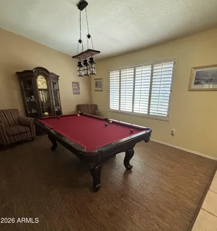 a room with pool table and windows