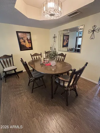 a view of a dining room with furniture wooden floor and a chandelier