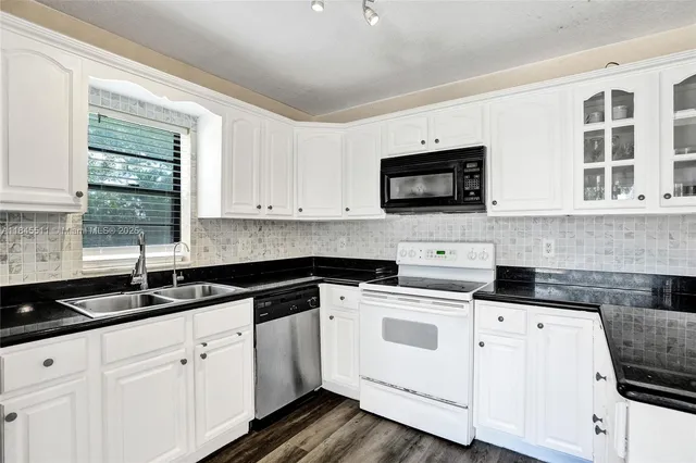 a bathroom with a sink mirror and toilet
