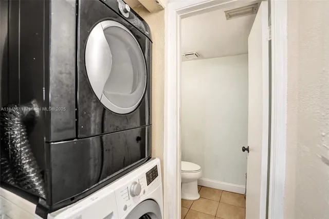 a bathroom with a toilet and a mirror