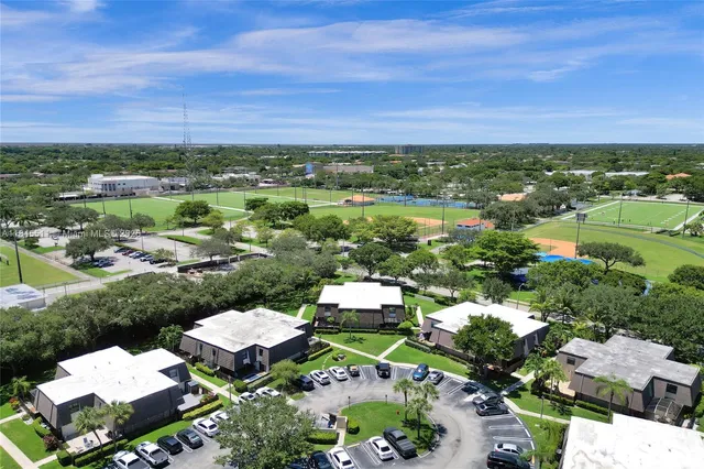 an aerial view of a house with a yard and lake view