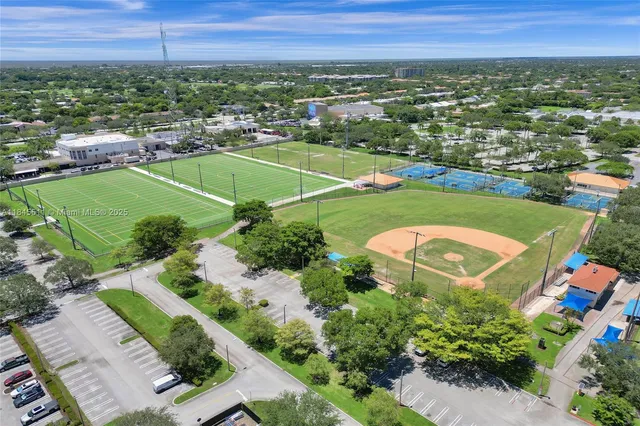 a view of backyard with small cabin and wooden fencing