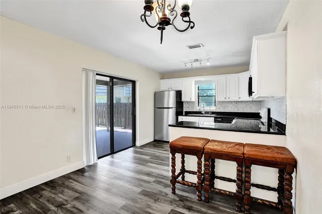 a kitchen with a refrigerator stove and sink