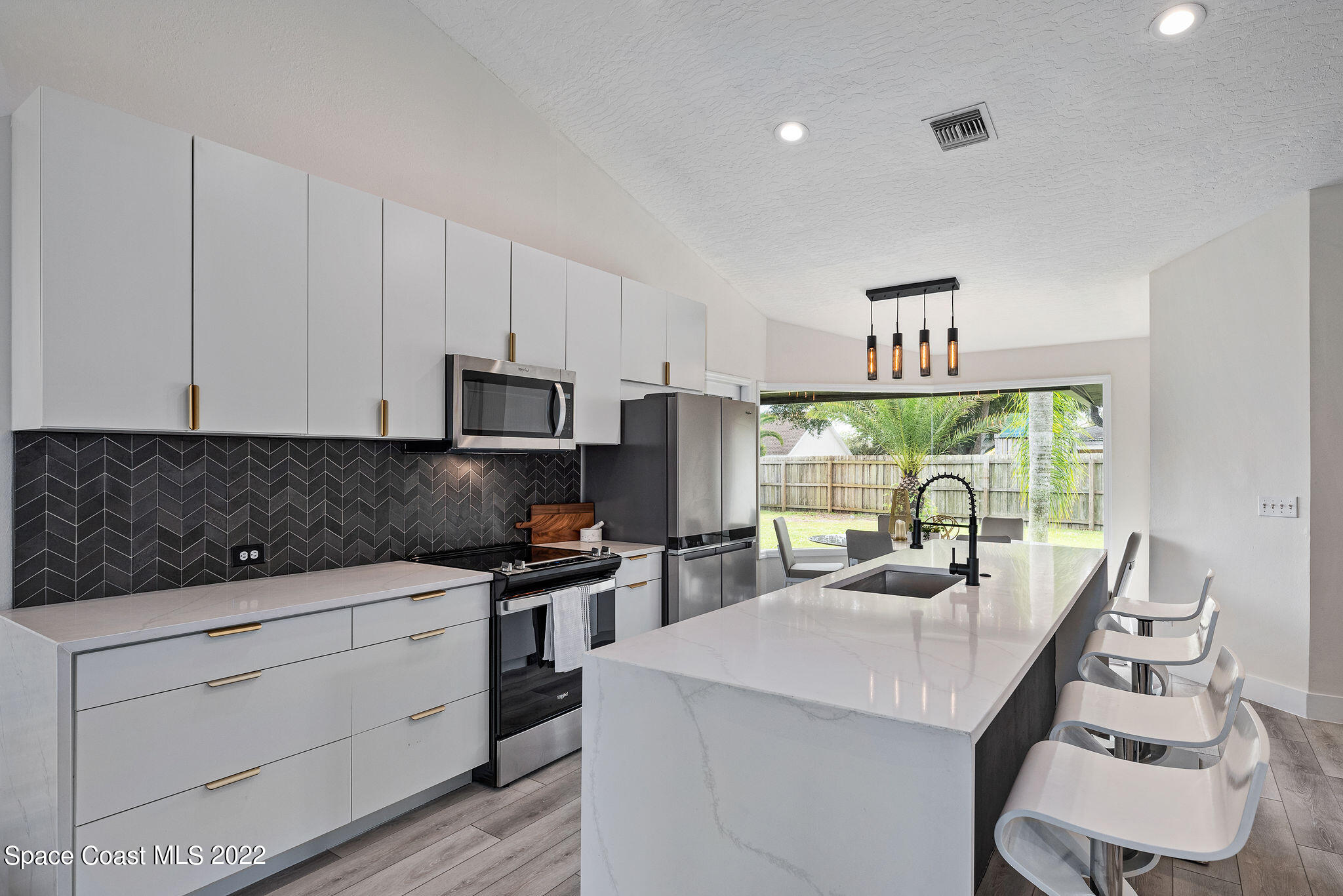 960 Falls Trail Malabar, FL 32950 - Photo 10 of 70 a kitchen with appliances a sink and cabinets