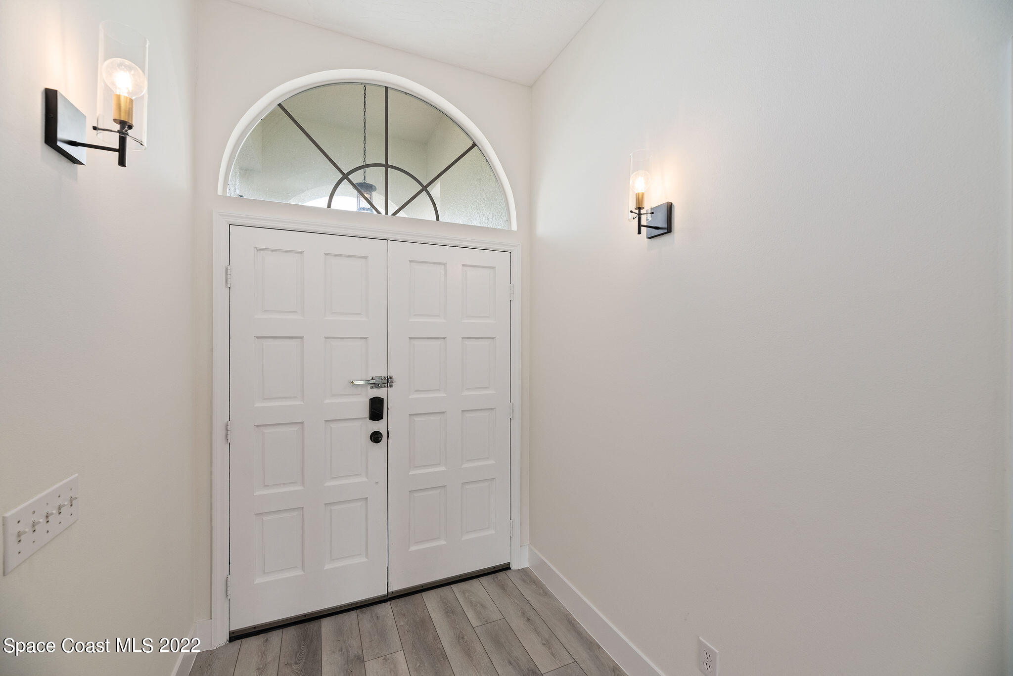 960 Falls Trail Malabar, FL 32950 - Photo 33 of 70 an empty room with wooden floor cabinet and window
