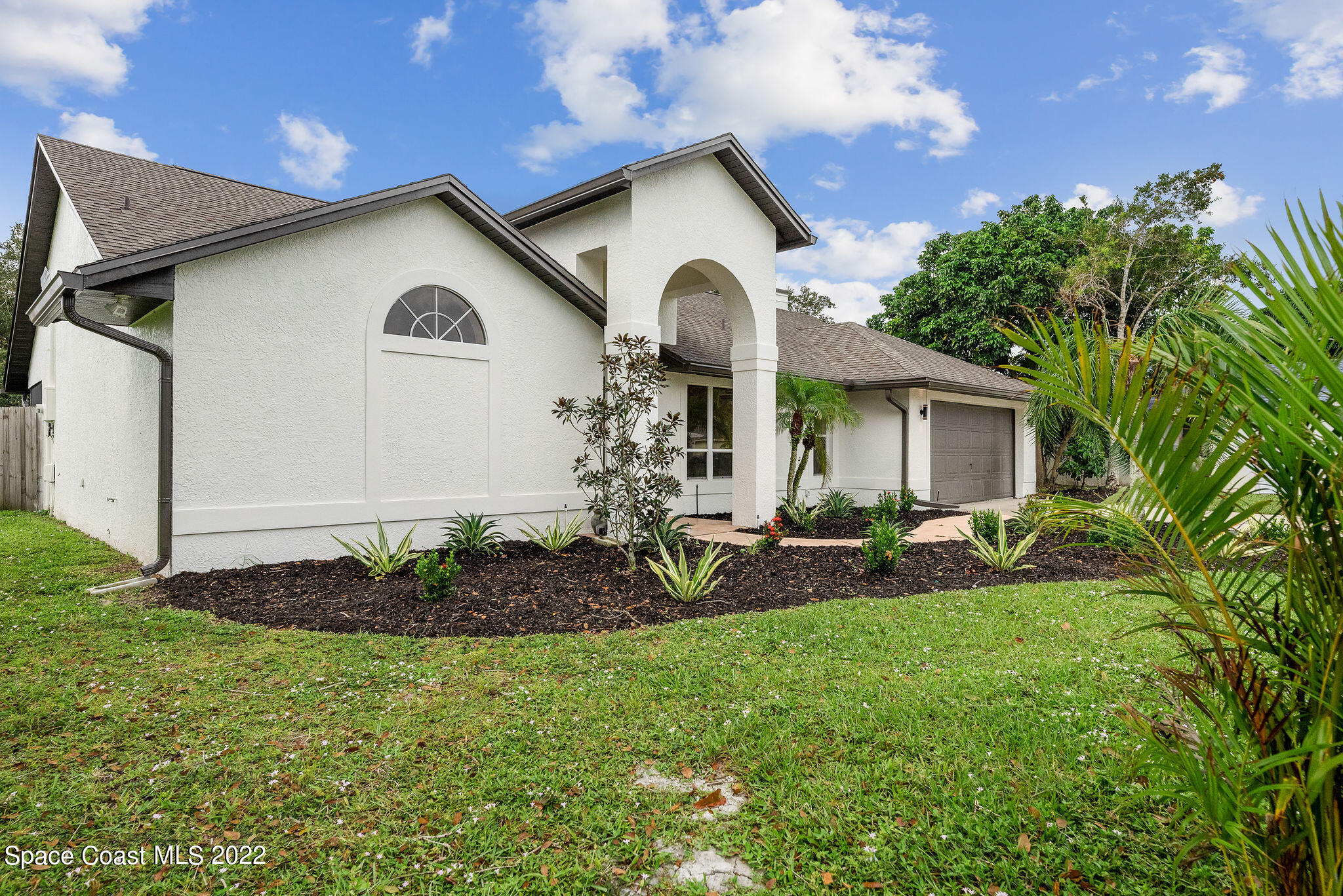 960 Falls Trail Malabar, FL 32950 - Photo 5 of 70 a front view of a house with garden