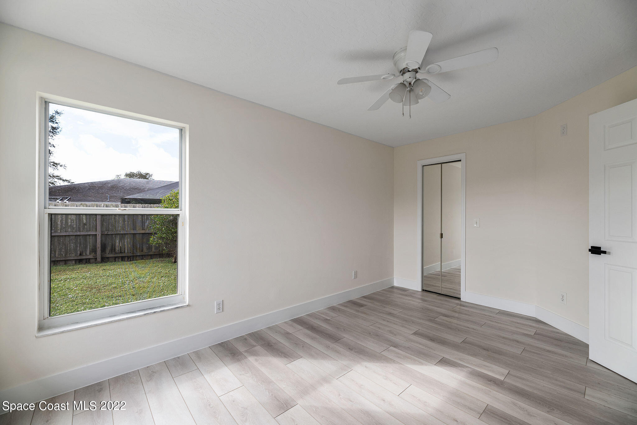 960 Falls Trail Malabar, FL 32950 - Photo 63 of 70 a view of a livingroom with a ceiling fan and window