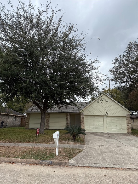 14207 Timberhaven Drive Houston, TX 77066 - Photo 1 of 14 a front view of a house with a yard and garage