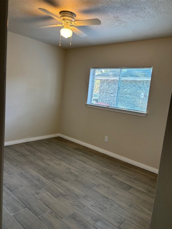 14207 Timberhaven Drive Houston, TX 77066 - Photo 12 of 14 a view of an empty room with wooden floor