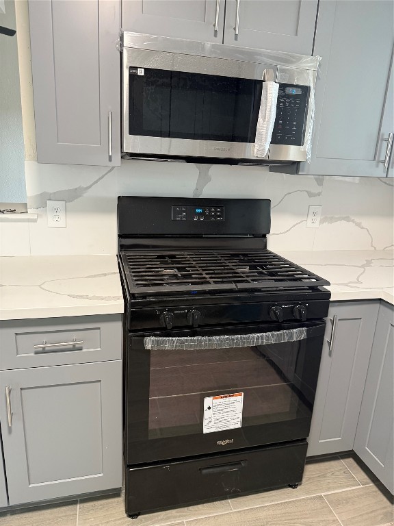 14207 Timberhaven Drive Houston, TX 77066 - Photo 6 of 14 a stove top oven sitting inside of a kitchen