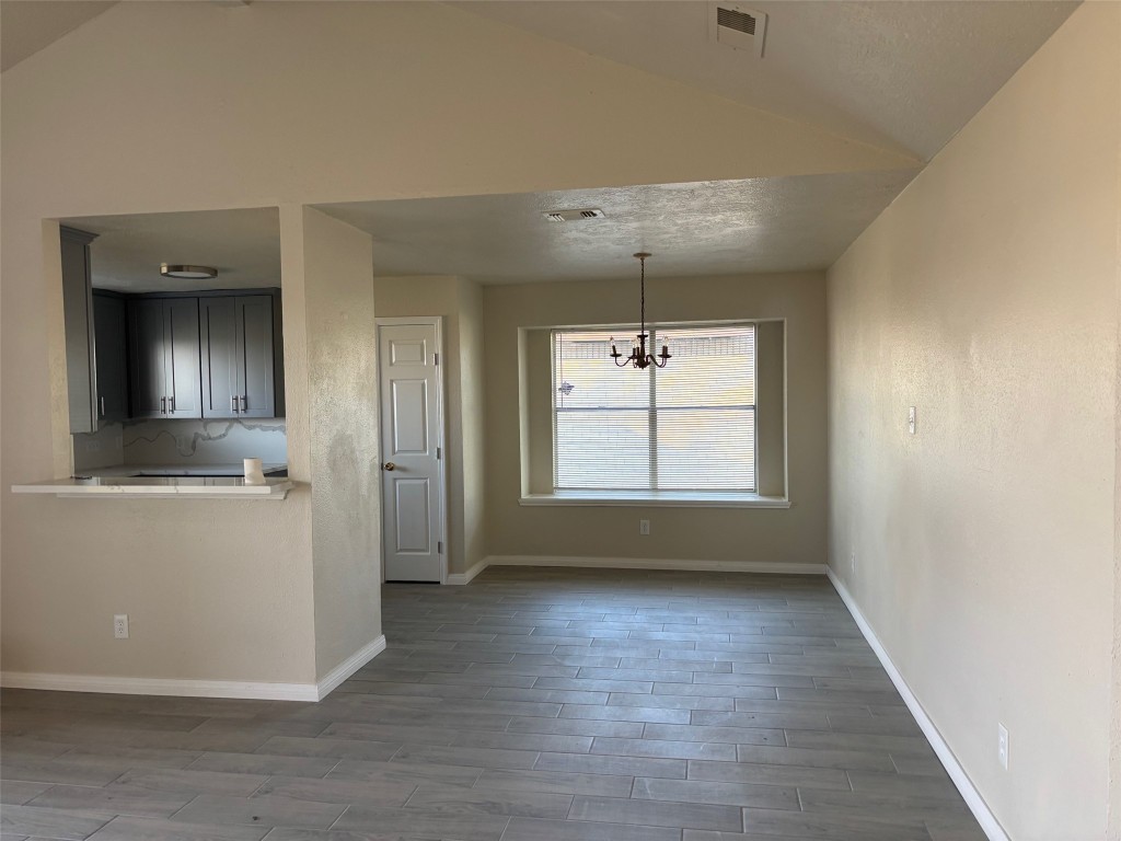 14207 Timberhaven Drive Houston, TX 77066 - Photo 9 of 14 an empty room with wooden floor and windows