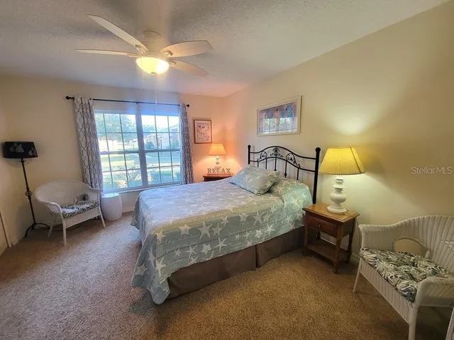 a spacious bedroom with a bed and a window