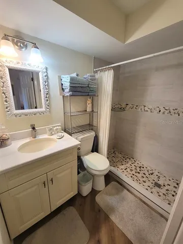 a bathroom with a sink toilet and shower