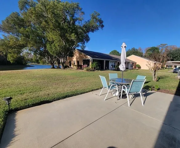 a view of a house with a yard and sitting area