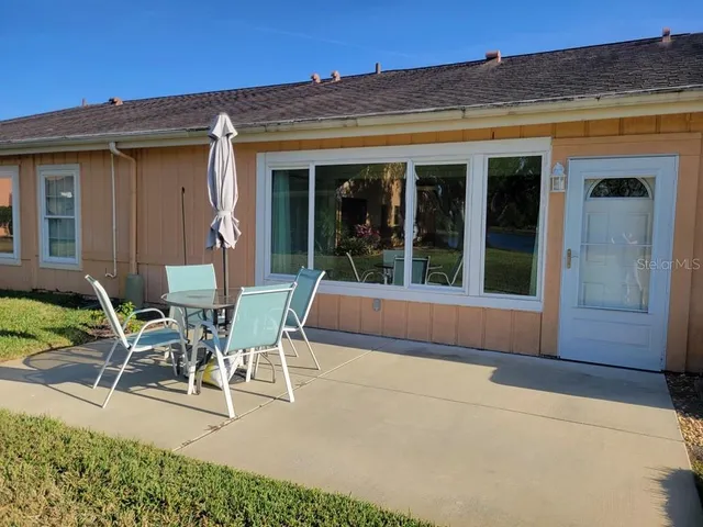 a view of a patio with table and chairs and potted plants