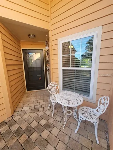 a view of a chairs and table in backyard of the house