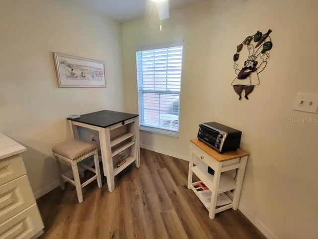 a room with a desk and wooden floor