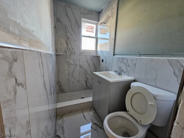 a bathroom with a toilet sink and shower