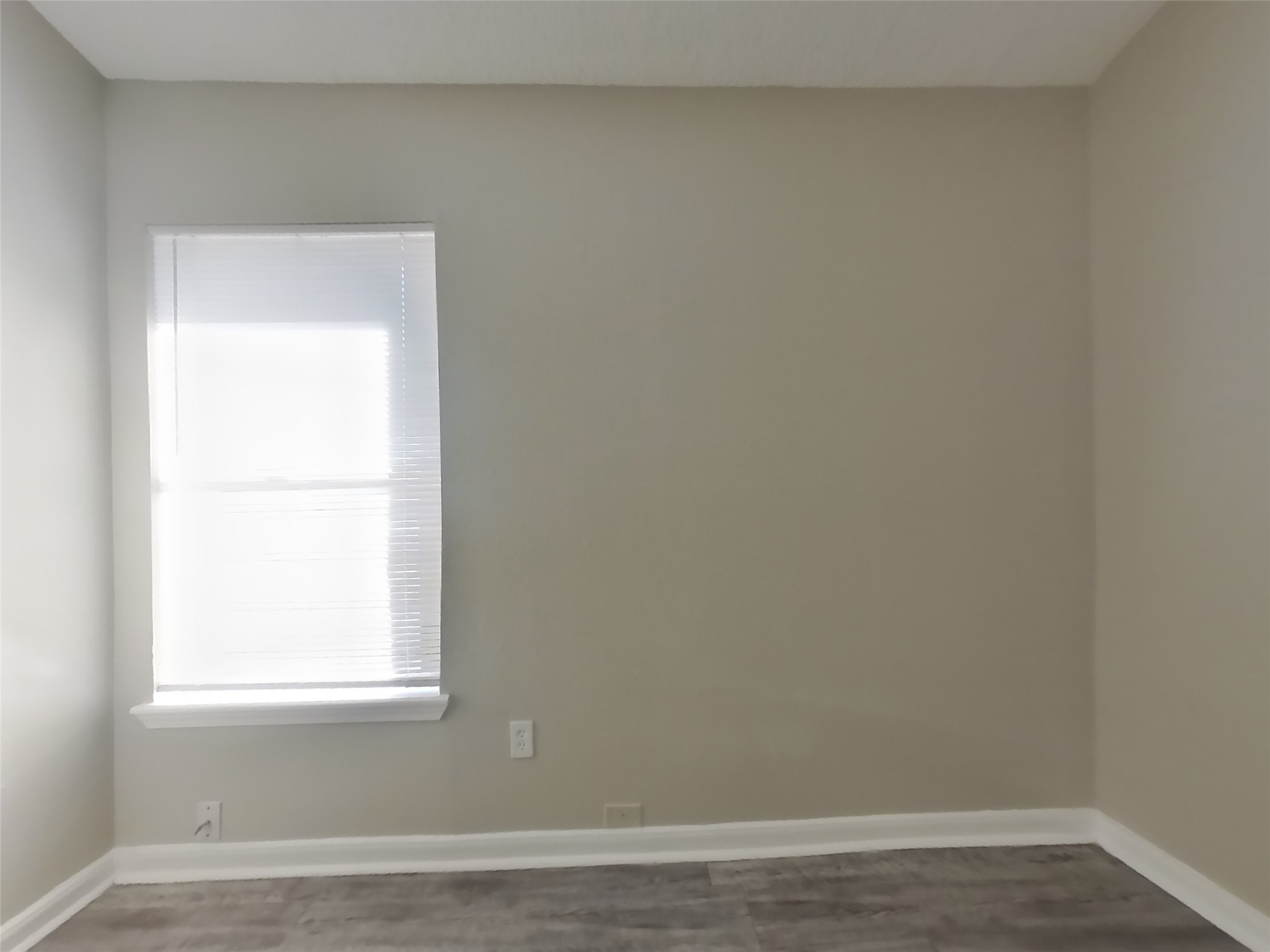 3131 Kelling Street Houston, TX 77045 - Photo 12 of 18 an empty room with wooden floor and a window