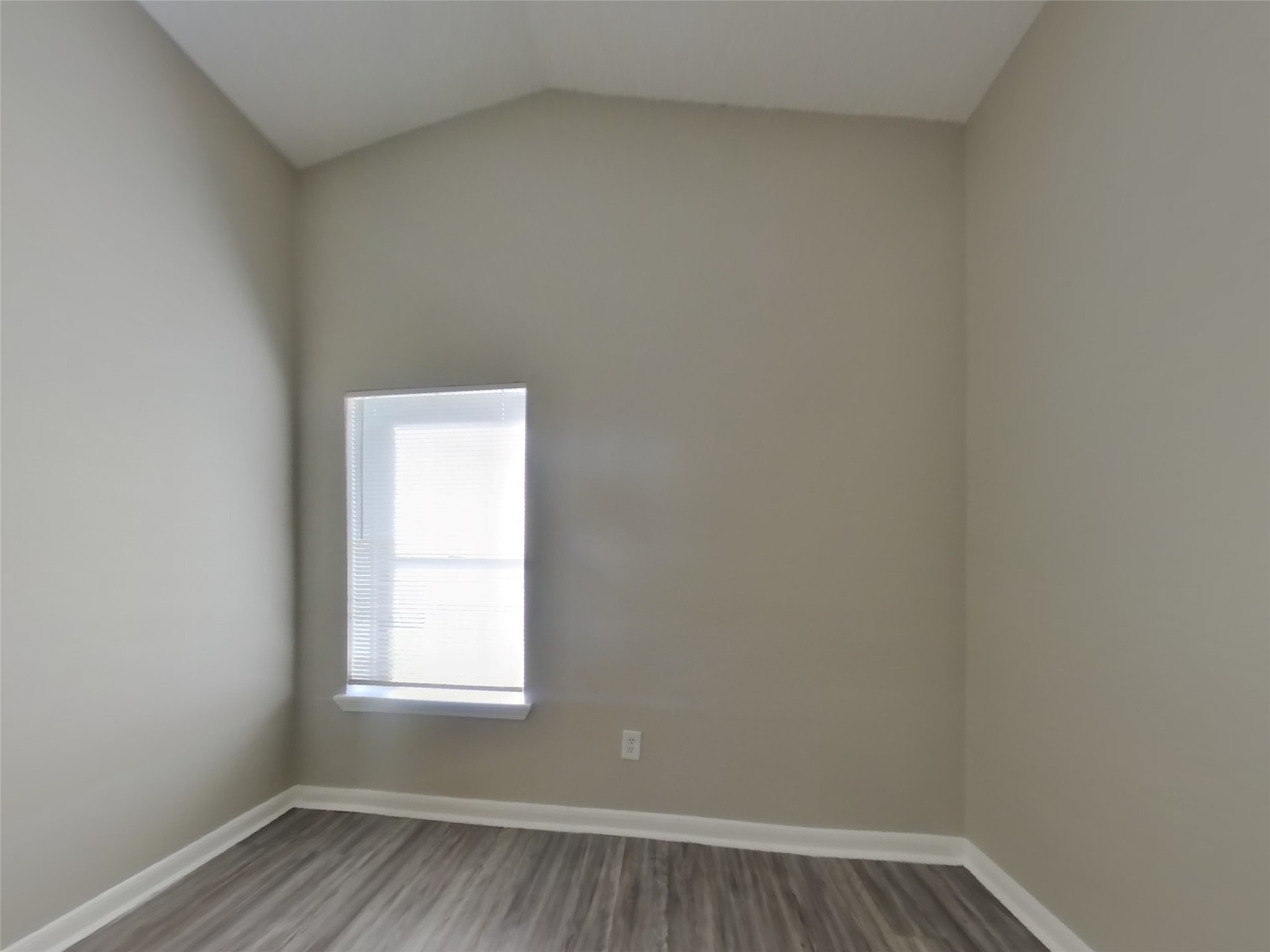 3131 Kelling Street Houston, TX 77045 - Photo 13 of 18 an empty room with wooden floor and windows