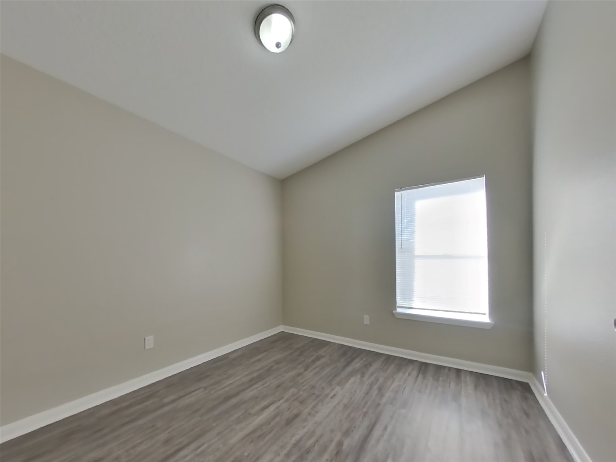 3131 Kelling Street Houston, TX 77045 - Photo 14 of 18 an empty room with wooden floor and windows