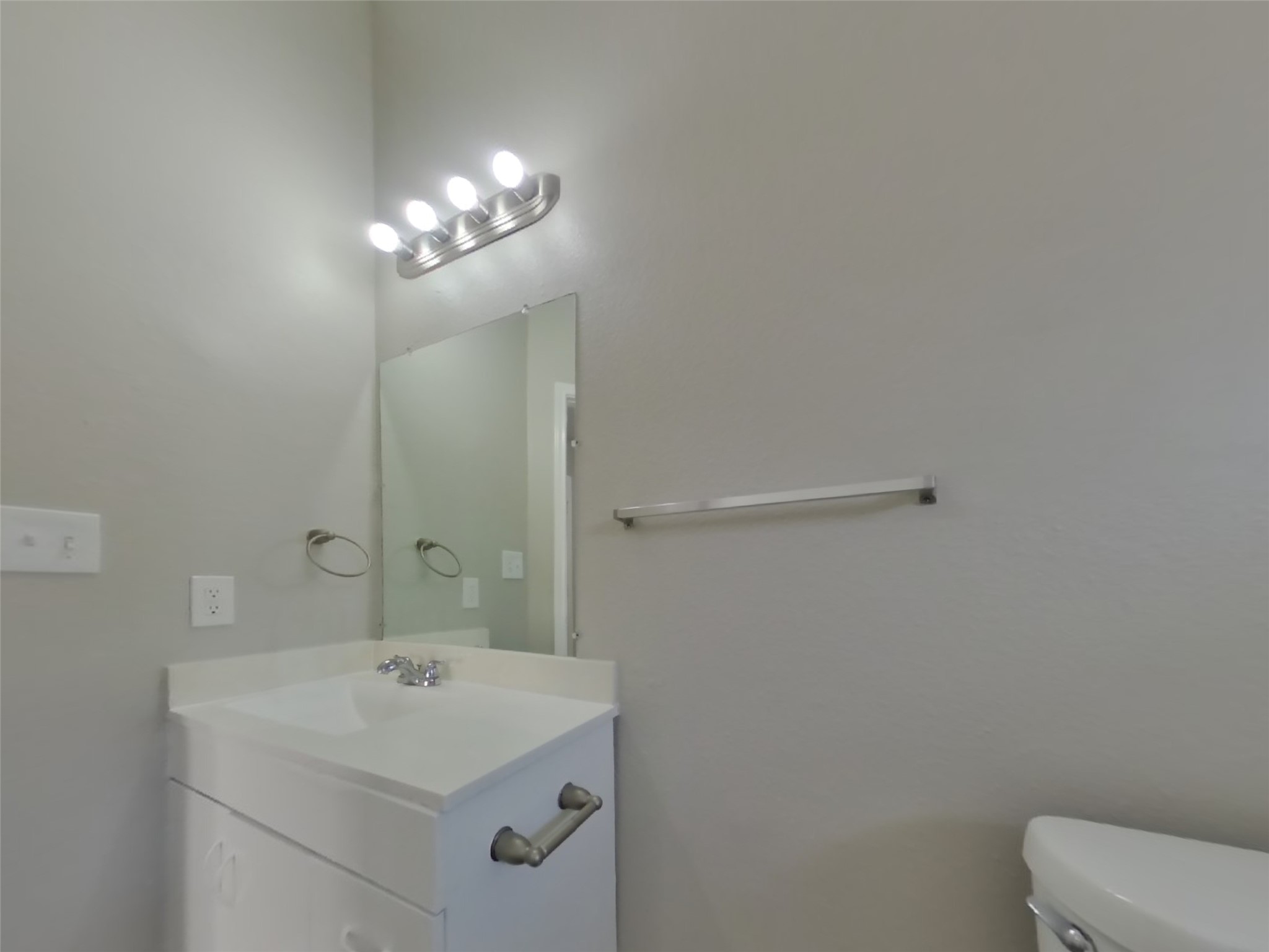 3131 Kelling Street Houston, TX 77045 - Photo 16 of 18 a bathroom with a sink a toilet and a mirror