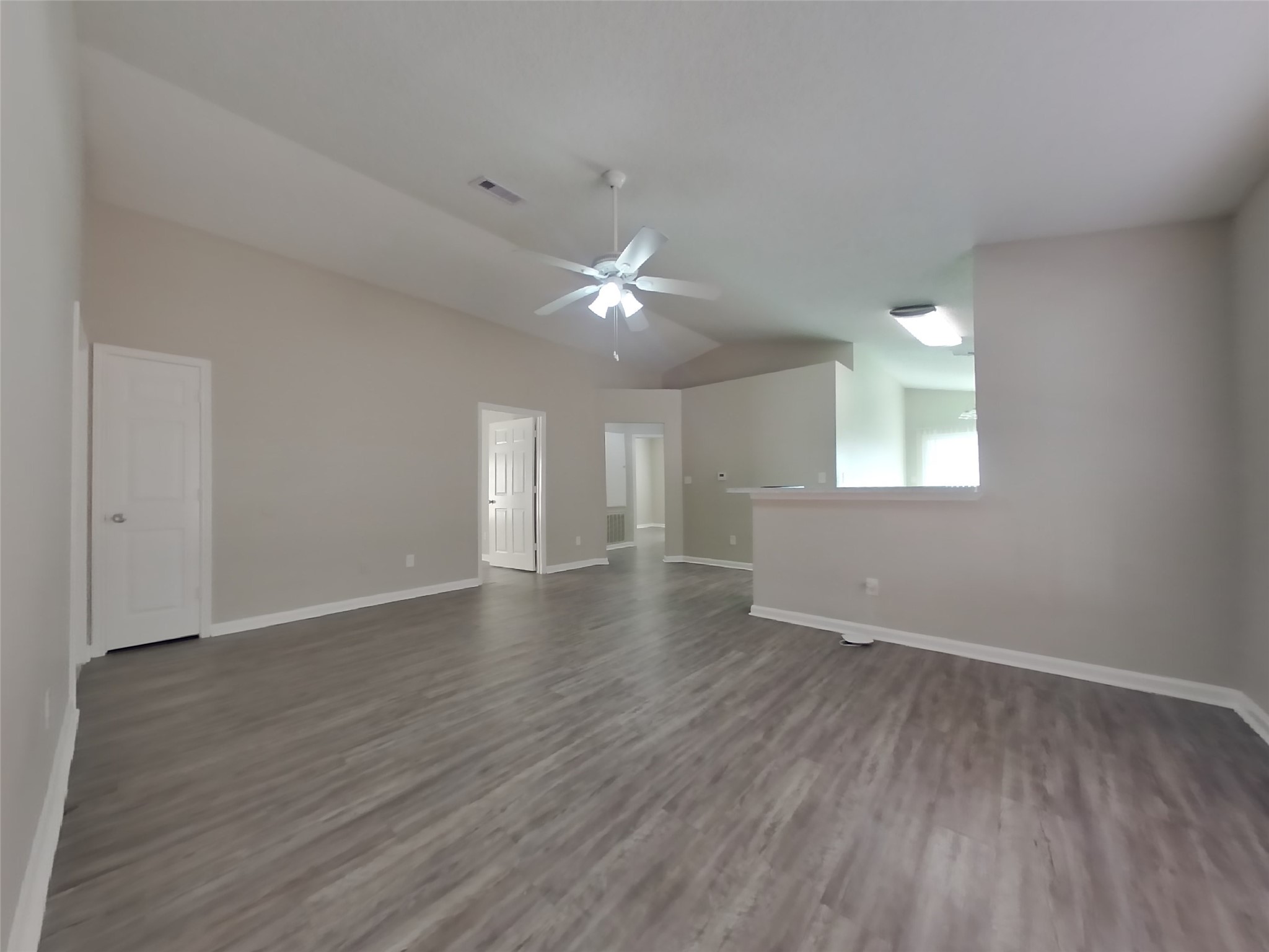 3131 Kelling Street Houston, TX 77045 - Photo 3 of 18 a view of an empty room with wooden floor and a window