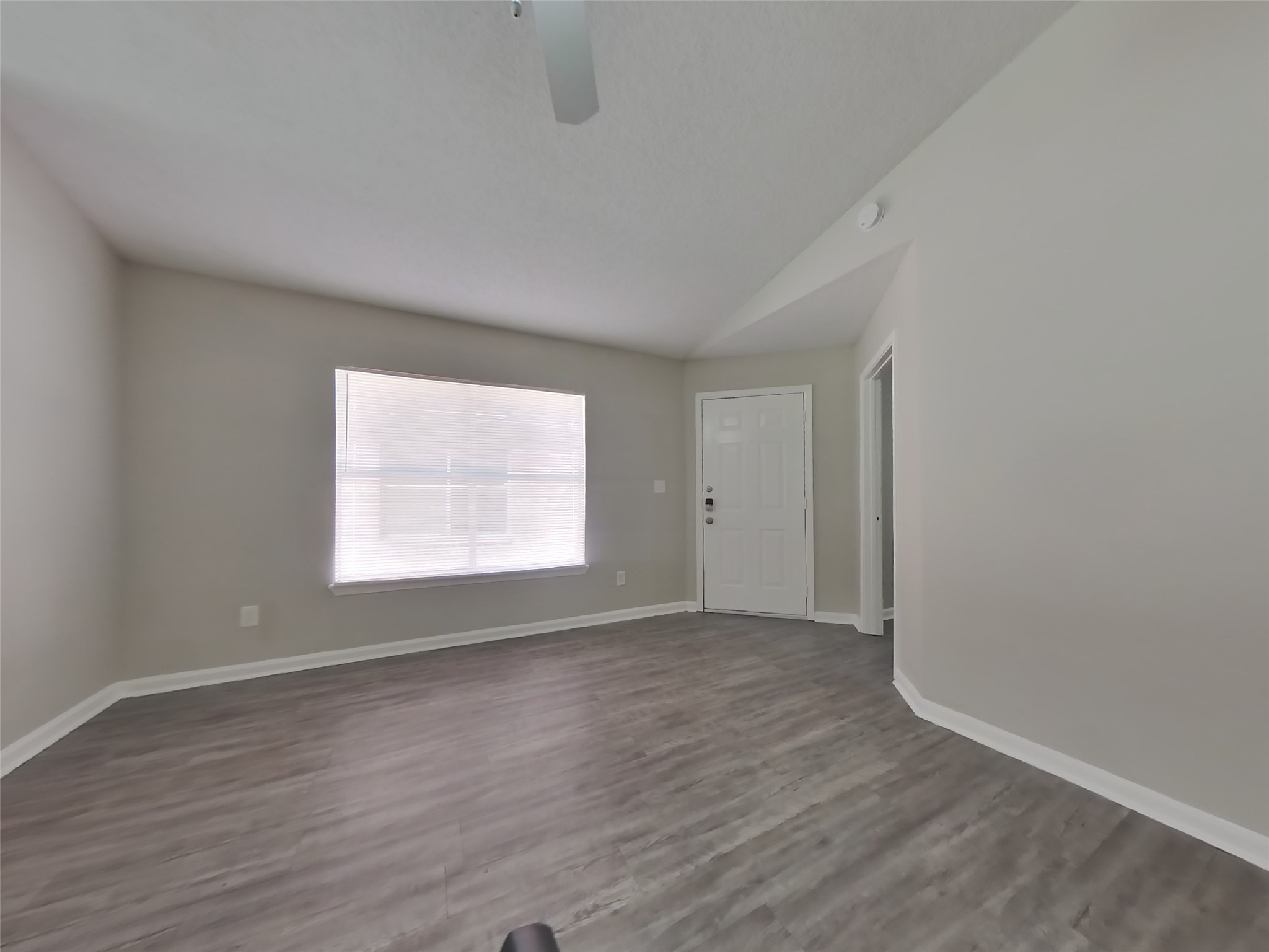 3131 Kelling Street Houston, TX 77045 - Photo 4 of 18 a view of an empty room with wooden floor and a window